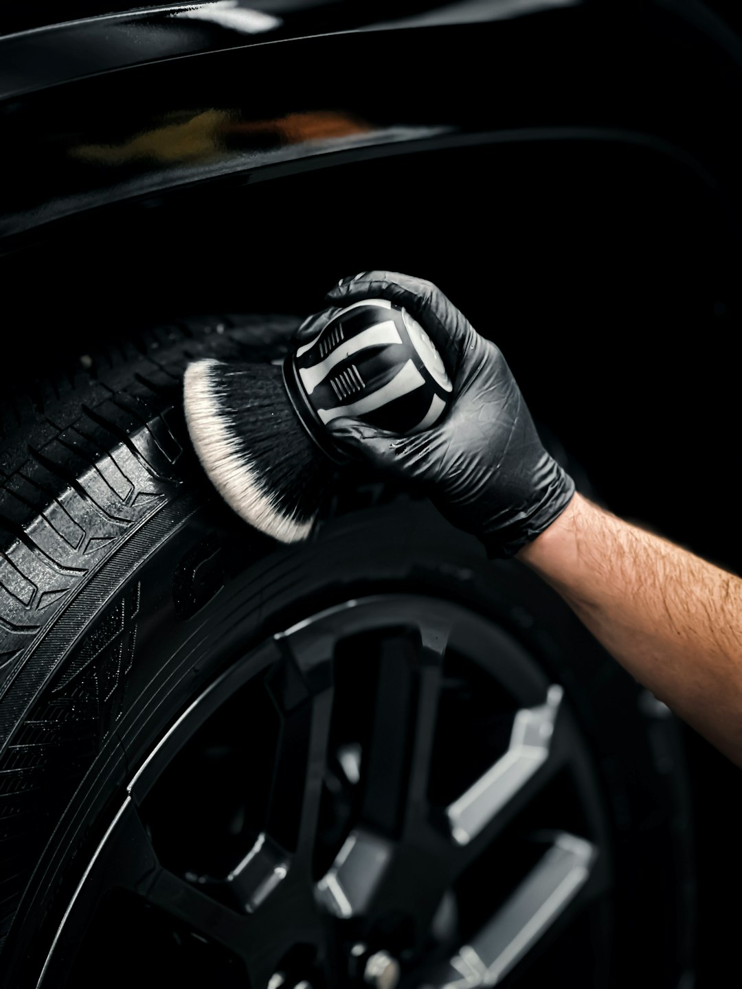 a-man-with-a-glove-on-his-hand-is-changing-the-tire-of-a-car-8k-t1ewtyss